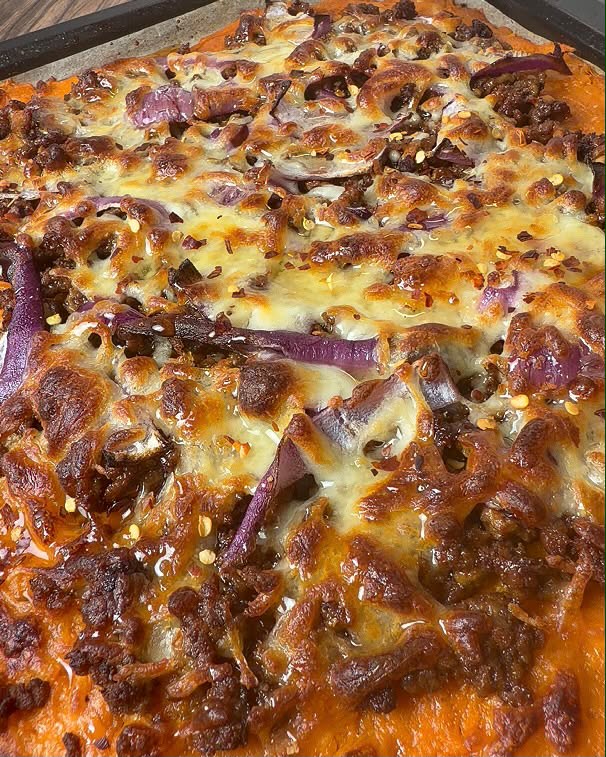 Sweet potato base pizza with beef, red onion and chilli flakes