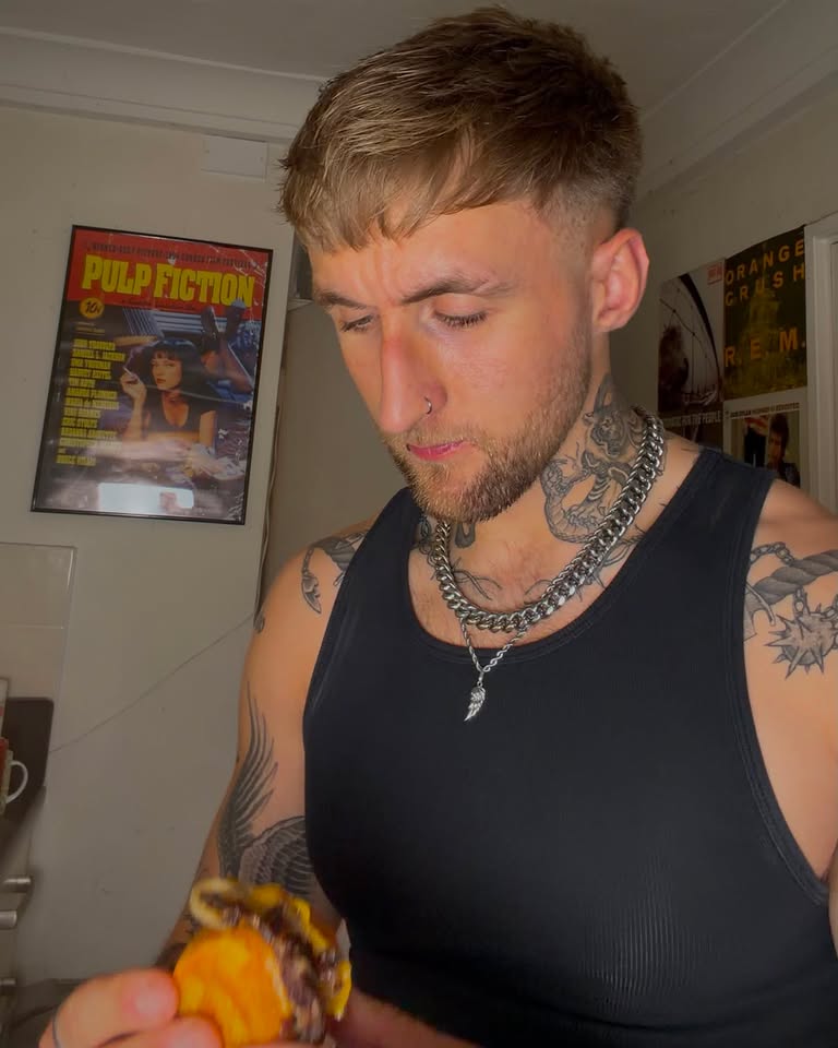 Max in the kitchen tucking into a burger